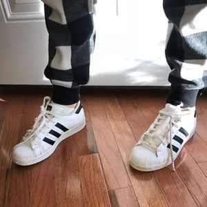 Black and white Adidas superstar.